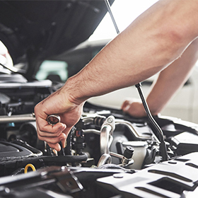 Mechanic hands on a car engine